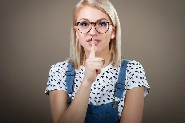 Woman with finger on lips, secret concept