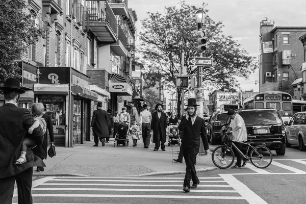 Jewish hassidic men cross the street.