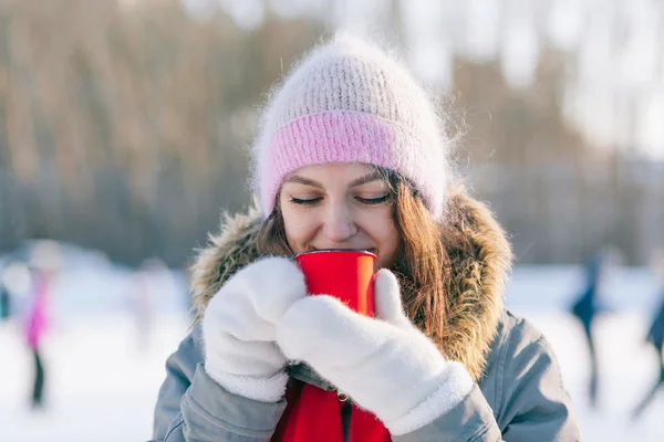 Woman holding winter cup close up