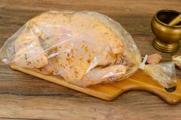 Raw Chicken with Herbs on Wood Background.