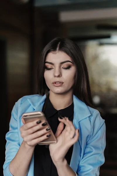 Beautiful girl works with technologise on the phone