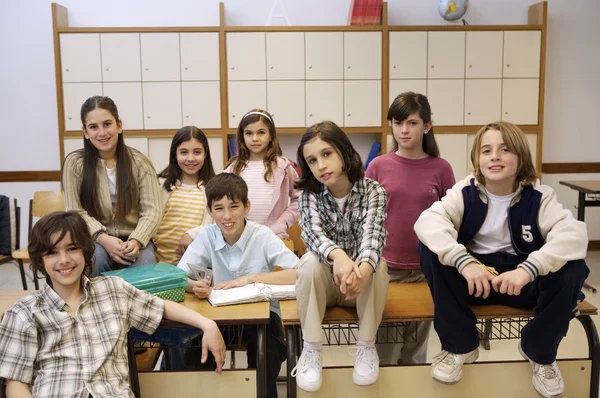 School children posing in classroom