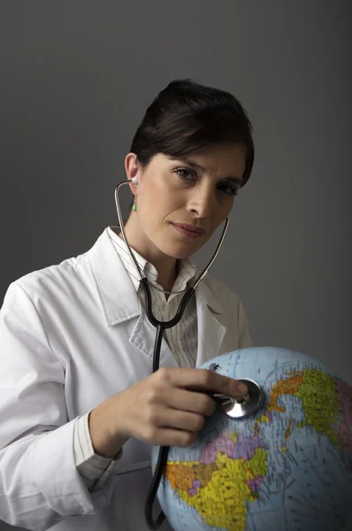 Doctor listening globe with stethoscope