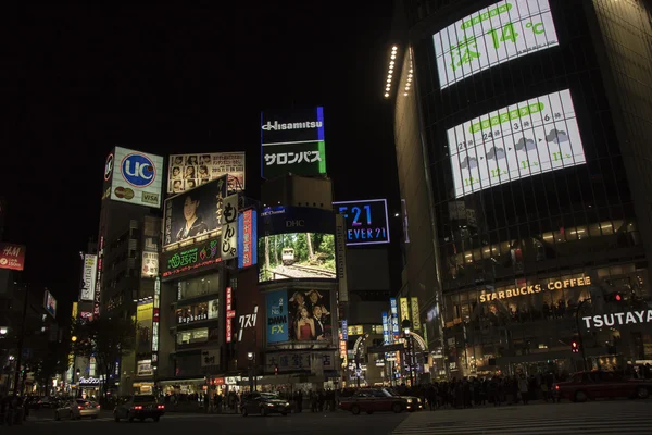 TOKYO, JAPAN - November 12, 2012: Pedestrians walk at Shibuya Crossing during the night. The scramble crosswalk is one of the largest in the world.