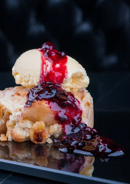 Apple pie served with ice cream and fruit jam