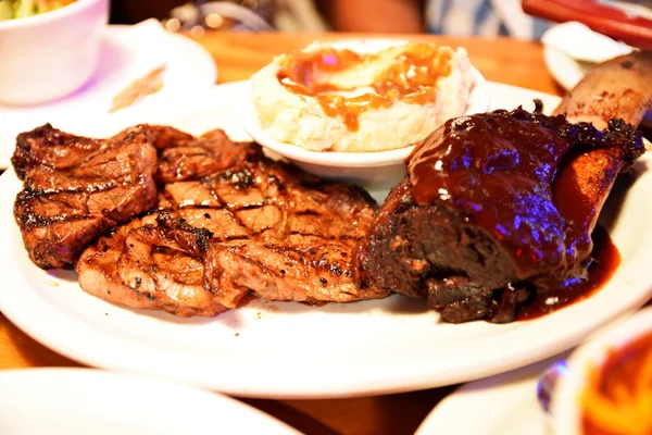 Rib eye steak with ribs and mash potato at the restaurant