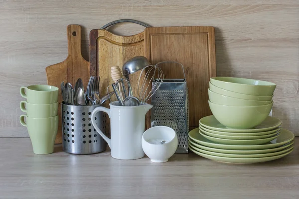 Crockery, tableware, utensils and other different stuff on wooden table-top.Kitchen still life as background for design.