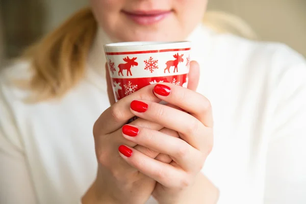 Close up of hands with a cup.