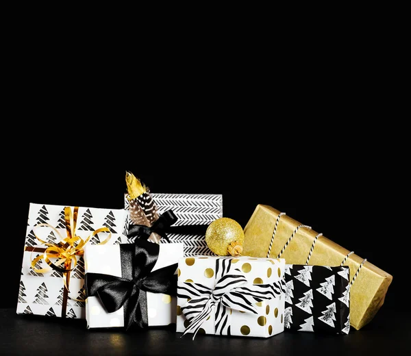 Modern painted paper black and white presents wrap with  bow on a black background