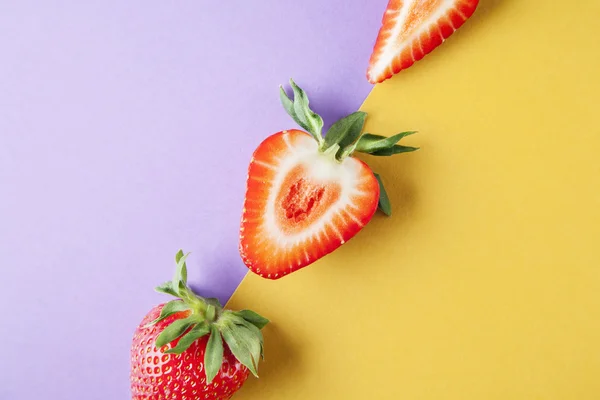 Strawberry on yellow violet background, fruits summer