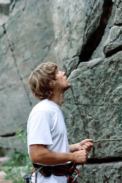 Man ensures the safety of climber