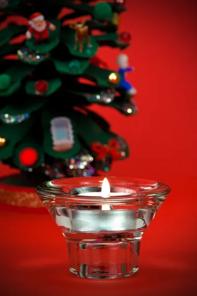 Beautiful votive candle with Christmas detail in the background