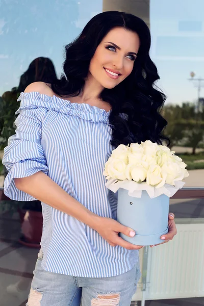 Gorgeous woman with bouquet of roses
