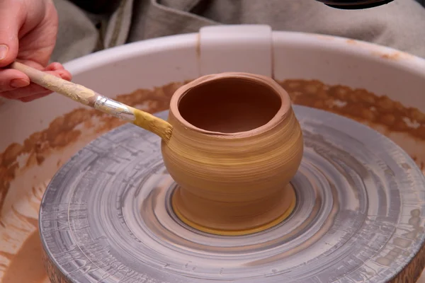 Clay pot on a potter wheel, modeling of pot hands, the sculpting of the hands