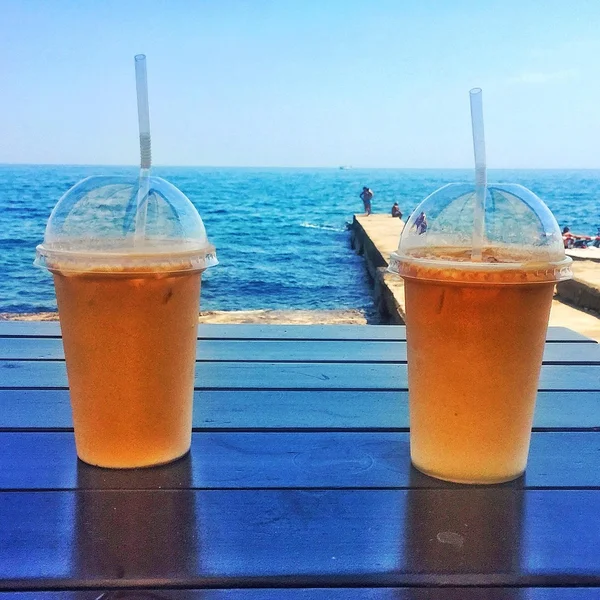 Two cups of ice coffee on table