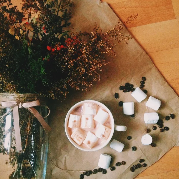 Cocoa with marshmallows and bouquet of dry flowers