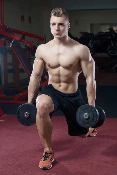 Muscular man topless doing lunges