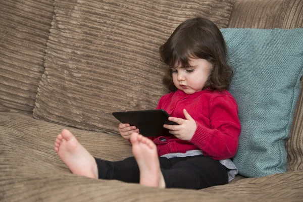 Toddler watching screen on tablet