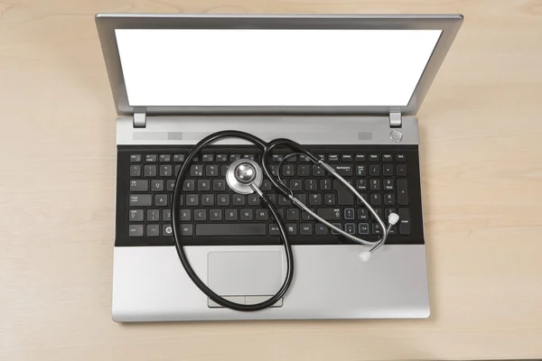 Doctors laptop with stethoscope on keyboard