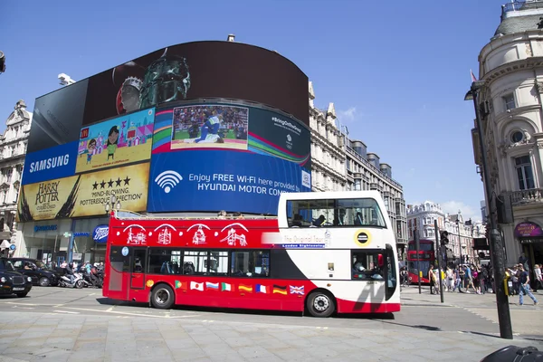 Site seeing bus passing big screen in piccadilly circus