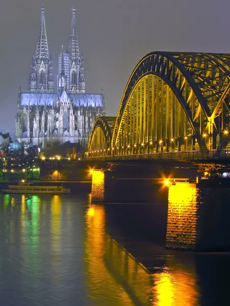 Cologne Cathedral and iron Bridge at night in Cologne, Germany.