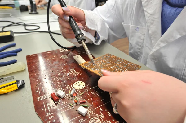 College students in electrical engineering in the classroom