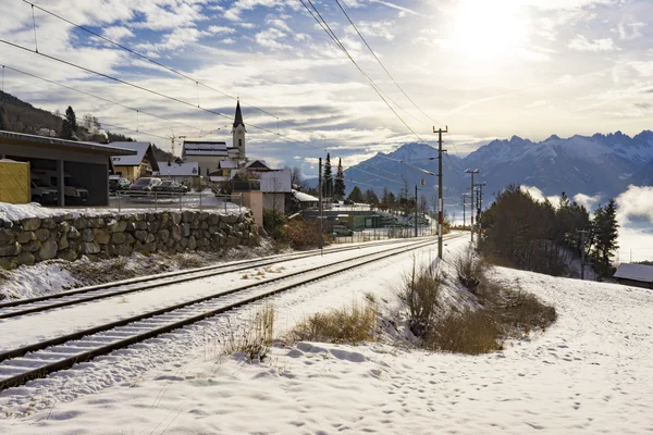 Snow covered railway tracks in a winter landscape