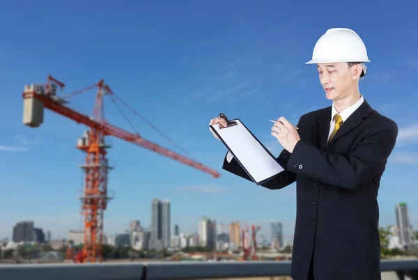 Asian business man or engineer in black suit at construction sit
