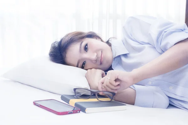 Pretty woman lying on bed after wake up and relaxing on the bed