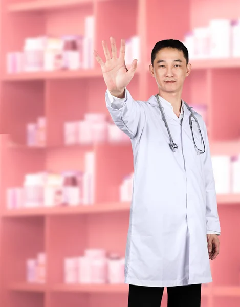 Male doctor up his hand in a Halt or Stop gesture