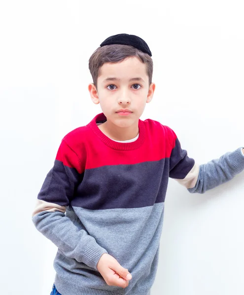 Beautiful Jewish boy with a black yarmulke, kippa in Hebrew