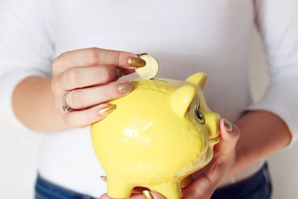 Woman holding yellow pig