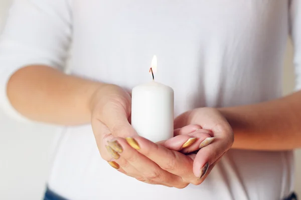 Woman with candle in hands