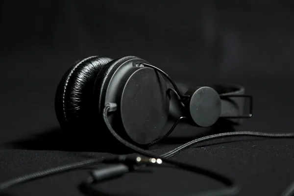 Black headphones on a black background