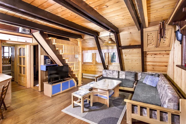 Traditional wooden interior with table and fixtures - mountain resort room interior