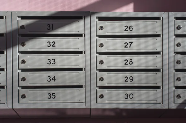 Metallic mailbox array tidy inside apartment houses