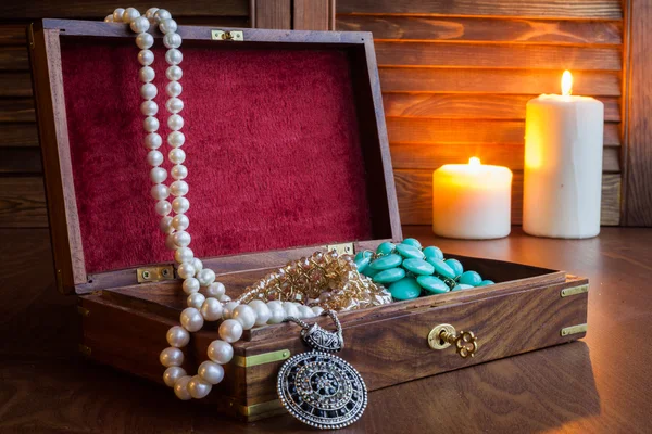 Jewelry box and jewelry on a wooden background