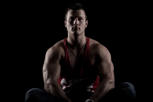 Strong Athletic man on black background