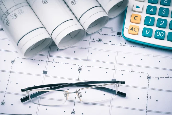 Ruler, eraser, glasses and a pencil on the floor plan - Bussines a still-life