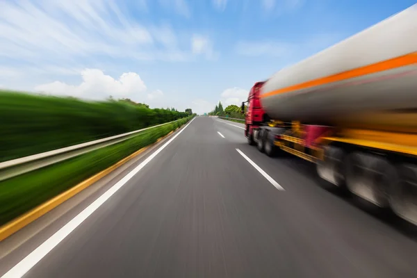 Motion blurred tanker truck on the highway. Chemical industry and pollution concept.