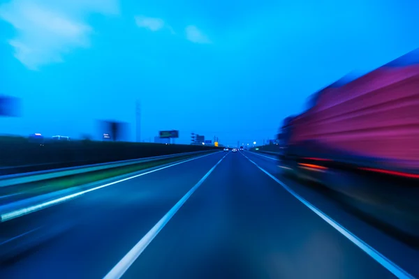Truck on a fast express road, motion blur