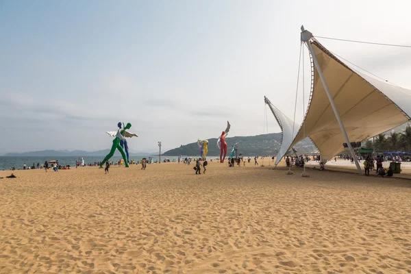 April 15, 2014: at noon on the beach in Dameisha, a group of unidentified people playing, it is not certain. Dameisha is one of the most popular beaches in Shenzhen.