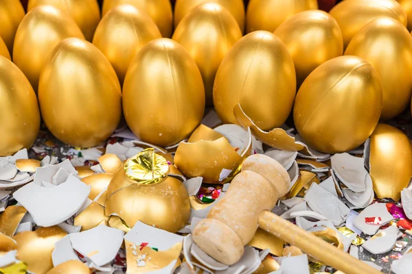 A lucky game, with a wooden hammer smashed the golden egg for the gift inside