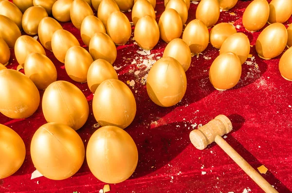 A lucky game, with a wooden hammer smashed the golden egg for the gift inside