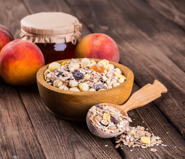 Rolled oats in bowl and muesli ingredients