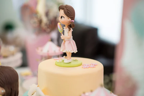Marzipan Dolls next to a birthday cake