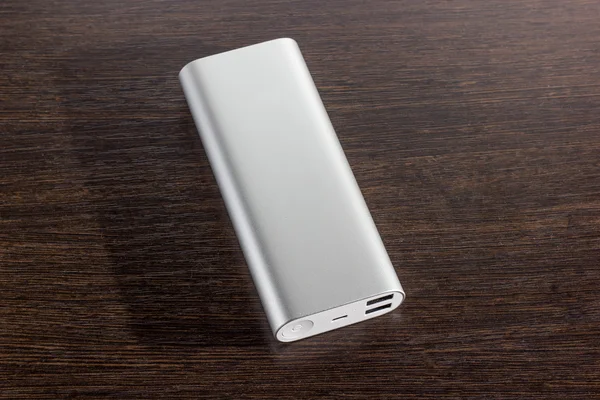 Silver aluminum power banks - dark wooden background