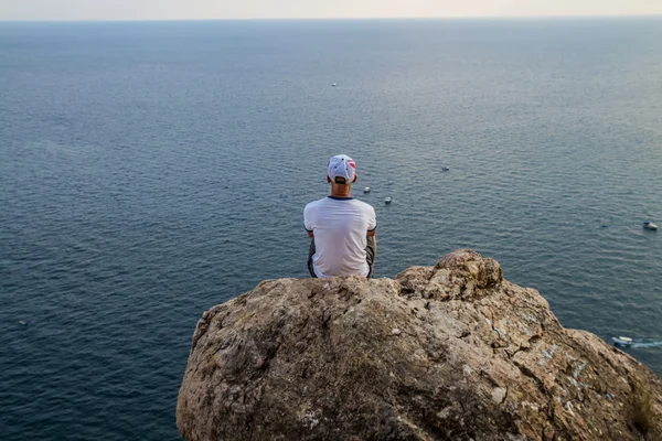 Young man  on the edge of a cliff