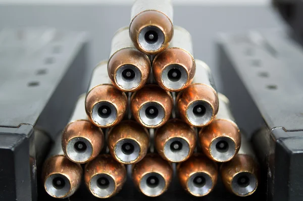 Hollow point, copper jacketed bullets stacked in a pyramid betwe