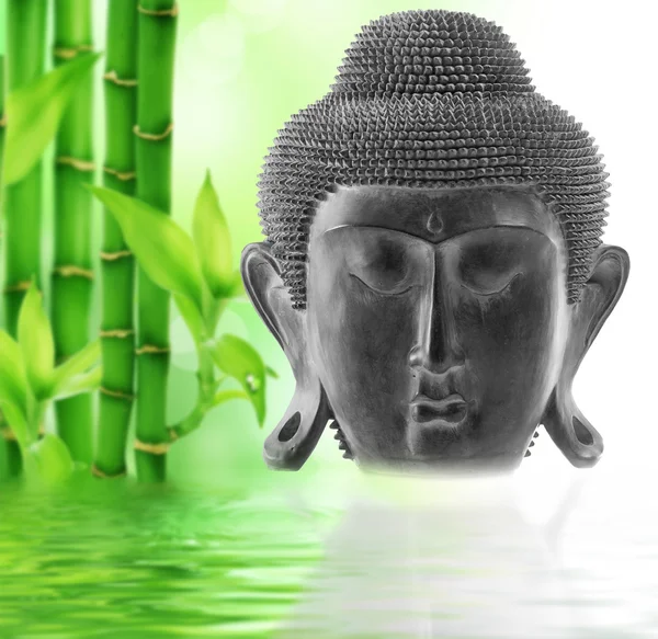 Front view of Buddha\'s face on bamboo background
